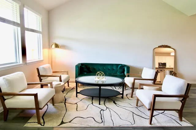 a living room with furniture and a potted plant