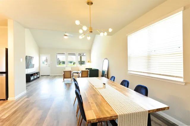 a large dining space with furniture window and wooden floor