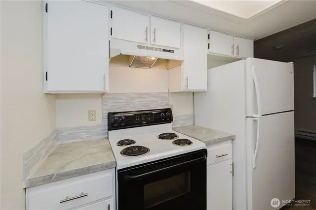 a kitchen with a stove and a refrigerator