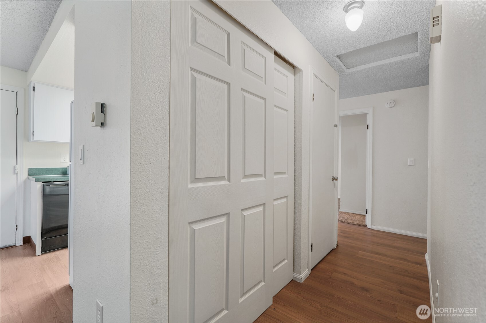 70 East Huckleberry Drive Grapeview, WA 98546 - Photo 14 of 25 a view of a hallway with wooden floor