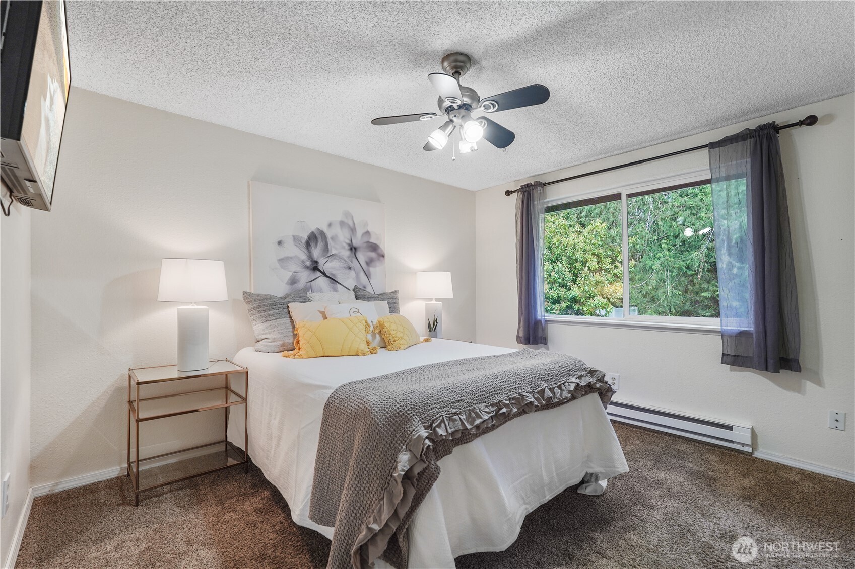 70 East Huckleberry Drive Grapeview, WA 98546 - Photo 15 of 25 a bedroom with a bed and a chandelier