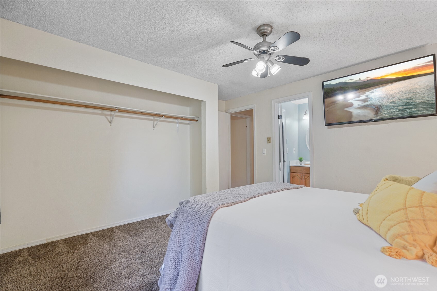 70 East Huckleberry Drive Grapeview, WA 98546 - Photo 16 of 25 a bedroom with a large bed and a chandelier