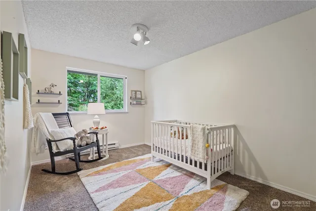 a view of a bedroom with furniture and a window