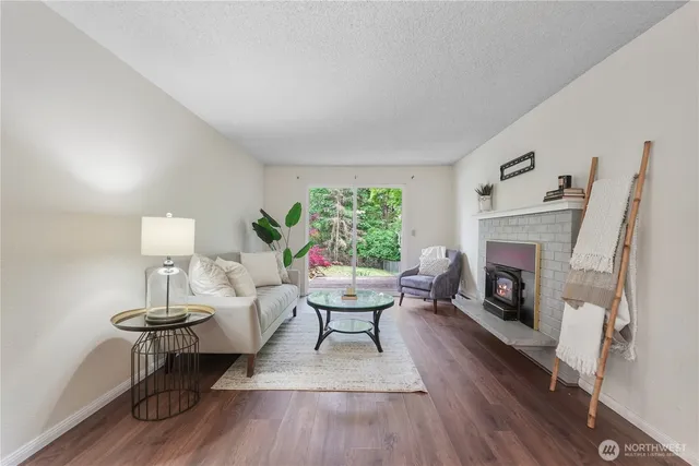 a living room with furniture a fireplace and a window
