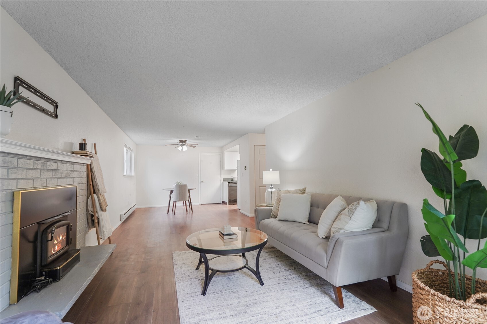 70 East Huckleberry Drive Grapeview, WA 98546 - Photo 7 of 25 a living room with furniture a fireplace and a potted plant