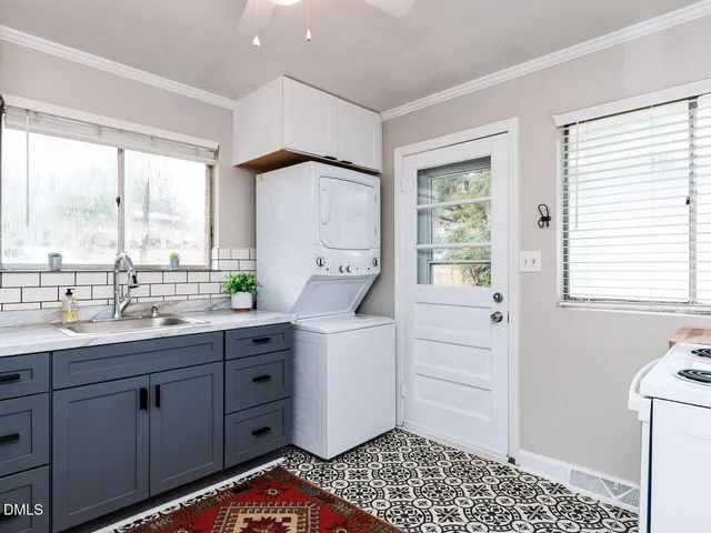 a kitchen with a sink a window and cabinets