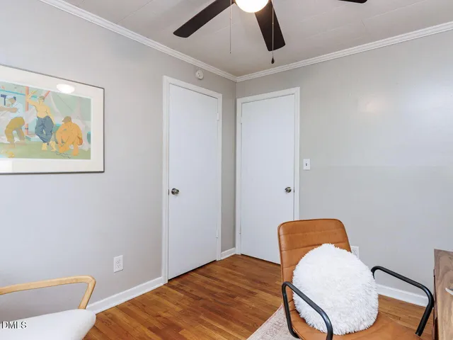 a bedroom with bed and wooden floor