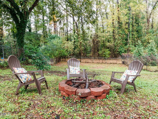 a view of a chairs and table in backyard