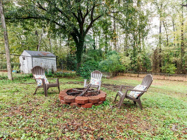 a view of a chairs in backyard of the house