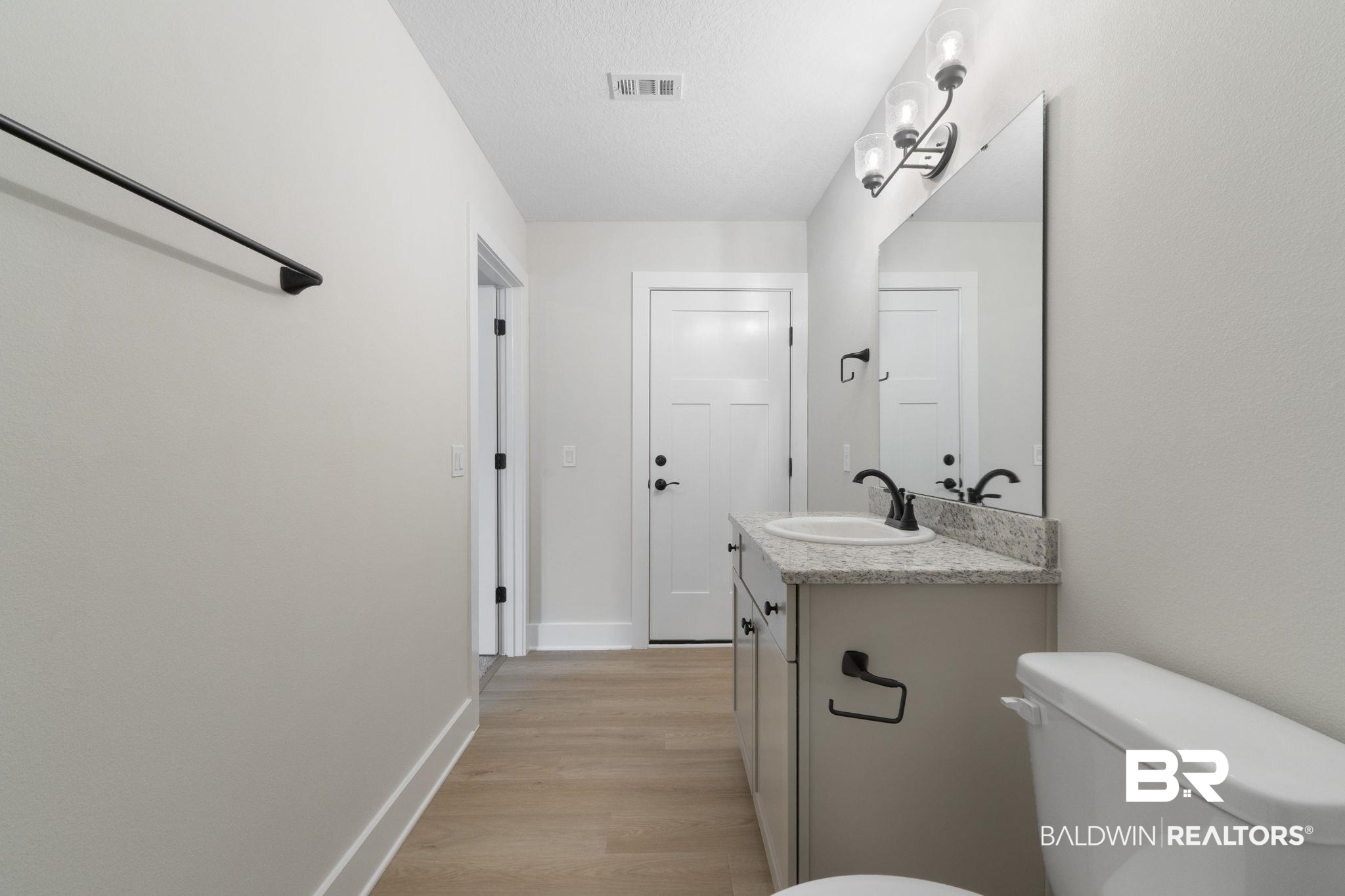 32563 Arbor Ridge Circle Lillian, AL 36549 - Photo 26 of 53 Bathroom featuring vanity, light wood-style floors, and a textured ceiling