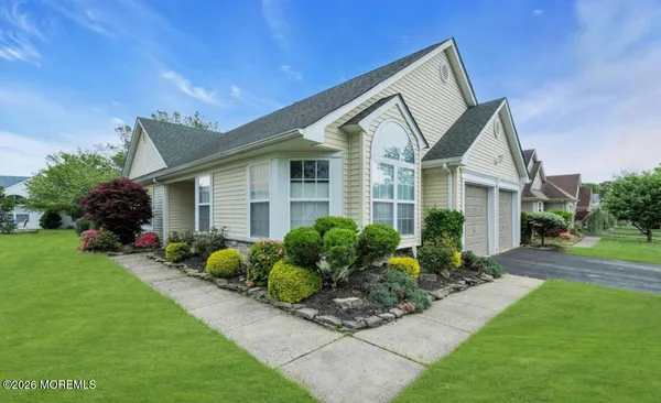 a front view of house with a garden