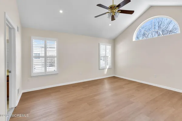 a view of a livingroom with a window and a ceiling fan