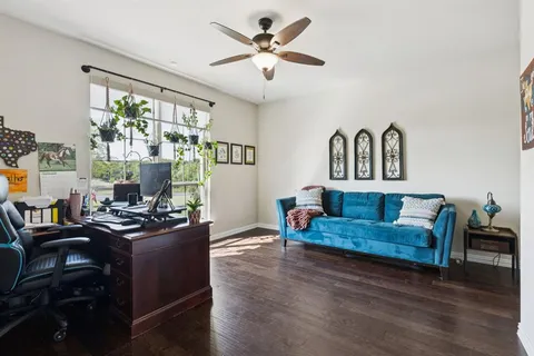 a living room with furniture and wooden floor