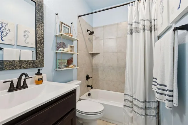 a bathroom with a sink a toilet and a shower