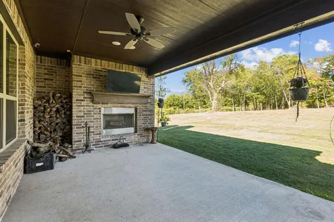 a view of an empty room with a fireplace and a window