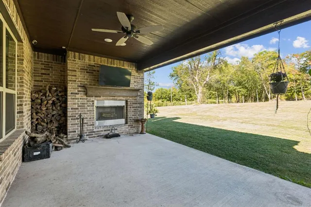 a view of an empty room with a fireplace and a window