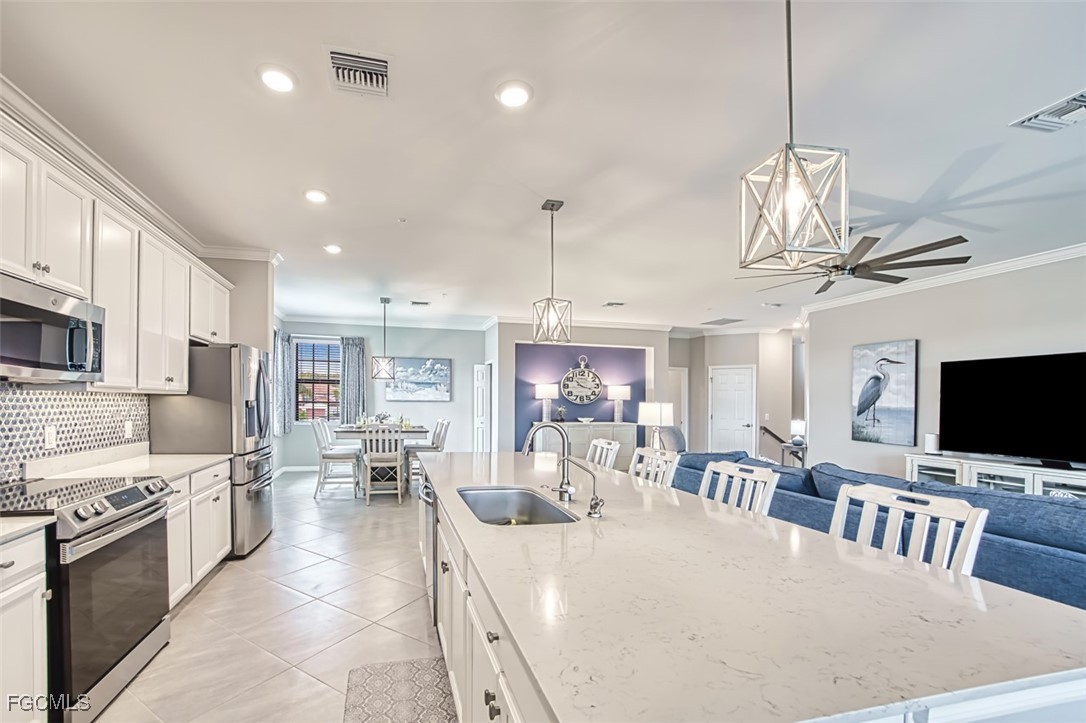 12000 Hawthorn Lake Drive, Unit 202 Fort Myers, FL 33913 - Photo 12 of 49 a large kitchen with a table and chairs in it