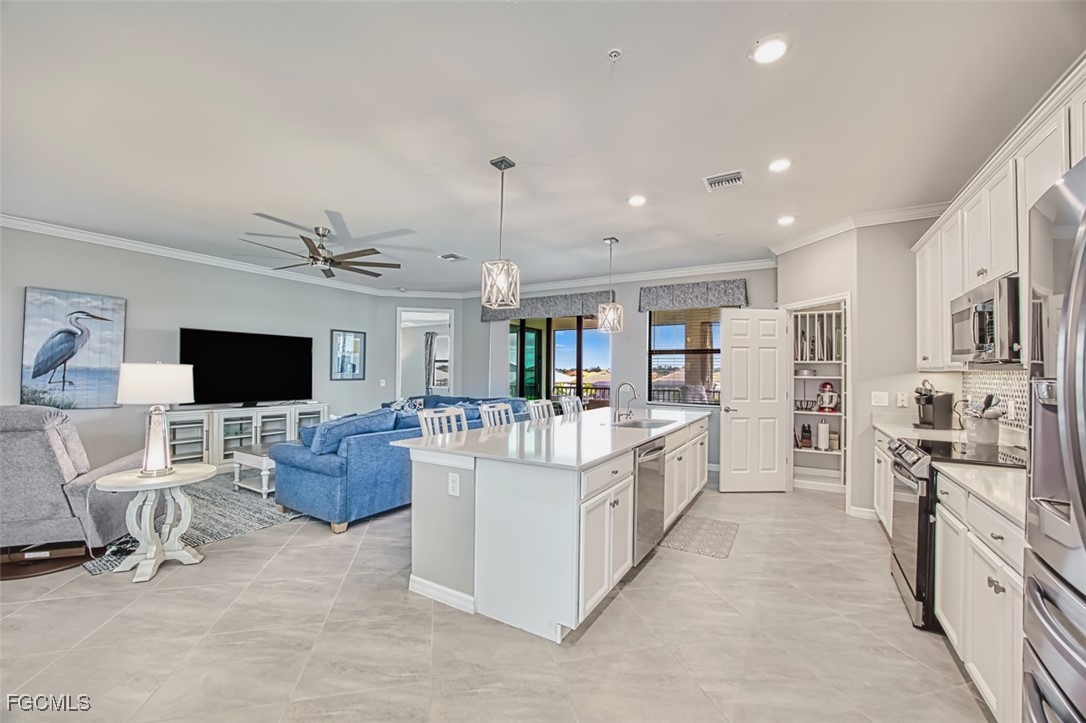 12000 Hawthorn Lake Drive, Unit 202 Fort Myers, FL 33913 - Photo 14 of 49 a large white kitchen with stainless steel appliances kitchen island granite countertop a large counter top and furniture