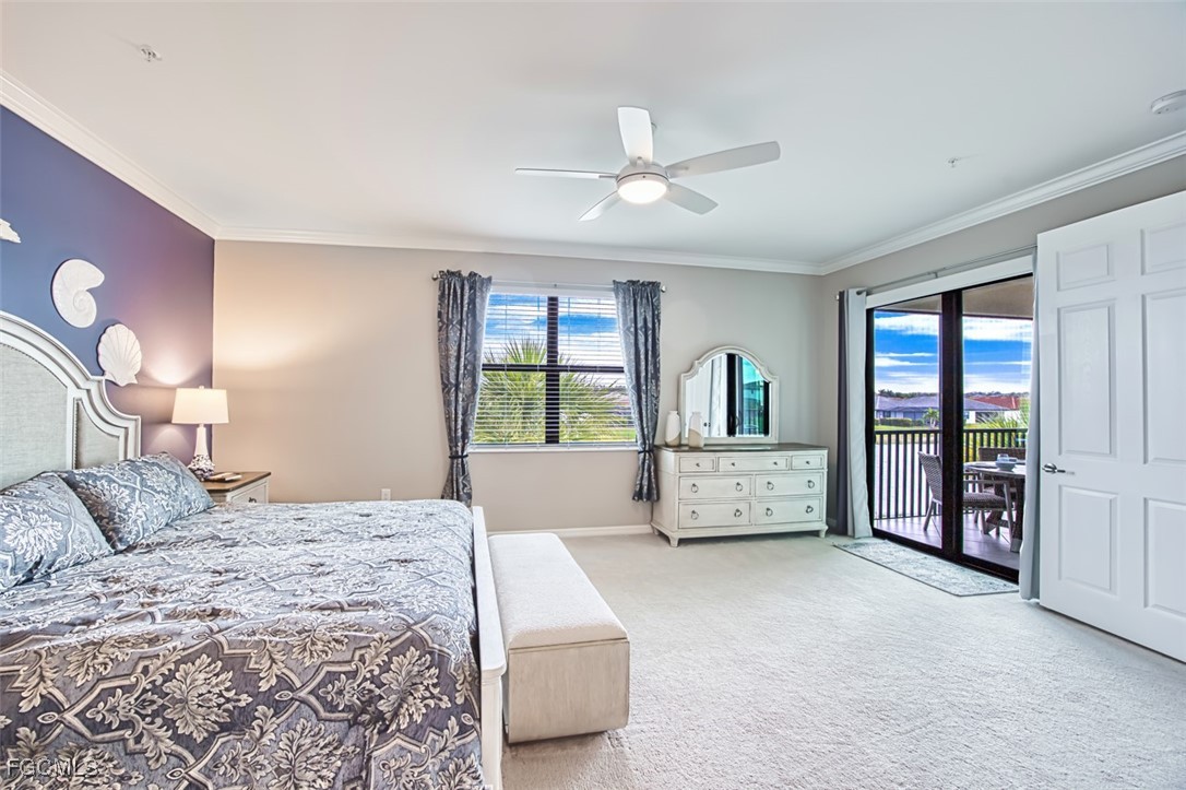 12000 Hawthorn Lake Drive, Unit 202 Fort Myers, FL 33913 - Photo 23 of 49 a bedroom with a large bed and a chandelier