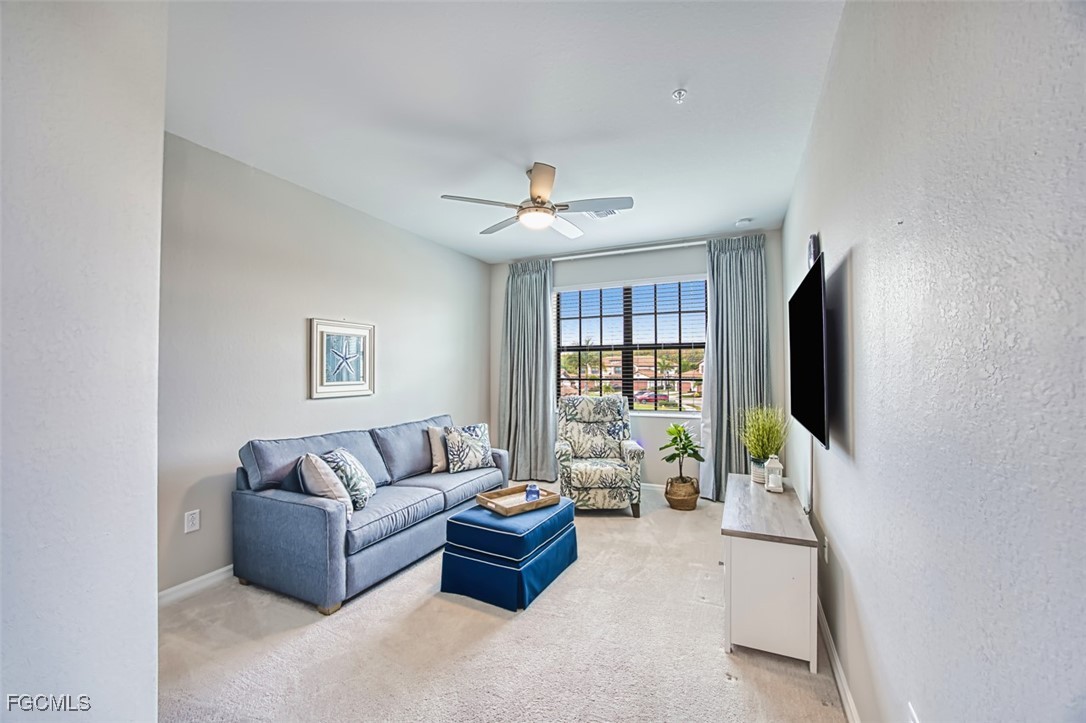 12000 Hawthorn Lake Drive, Unit 202 Fort Myers, FL 33913 - Photo 29 of 49 a living room with furniture and a flat screen tv