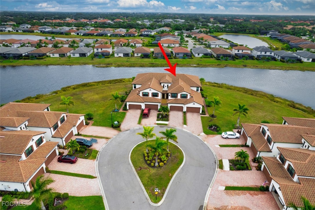 12000 Hawthorn Lake Drive, Unit 202 Fort Myers, FL 33913 - Photo 45 of 49 an aerial view of a house with a garden and lake view