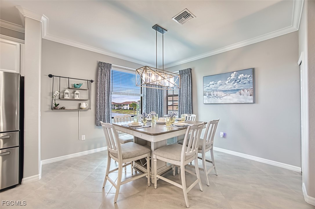 12000 Hawthorn Lake Drive, Unit 202 Fort Myers, FL 33913 - Photo 5 of 49 a view of a dining room with furniture window and wooden floor