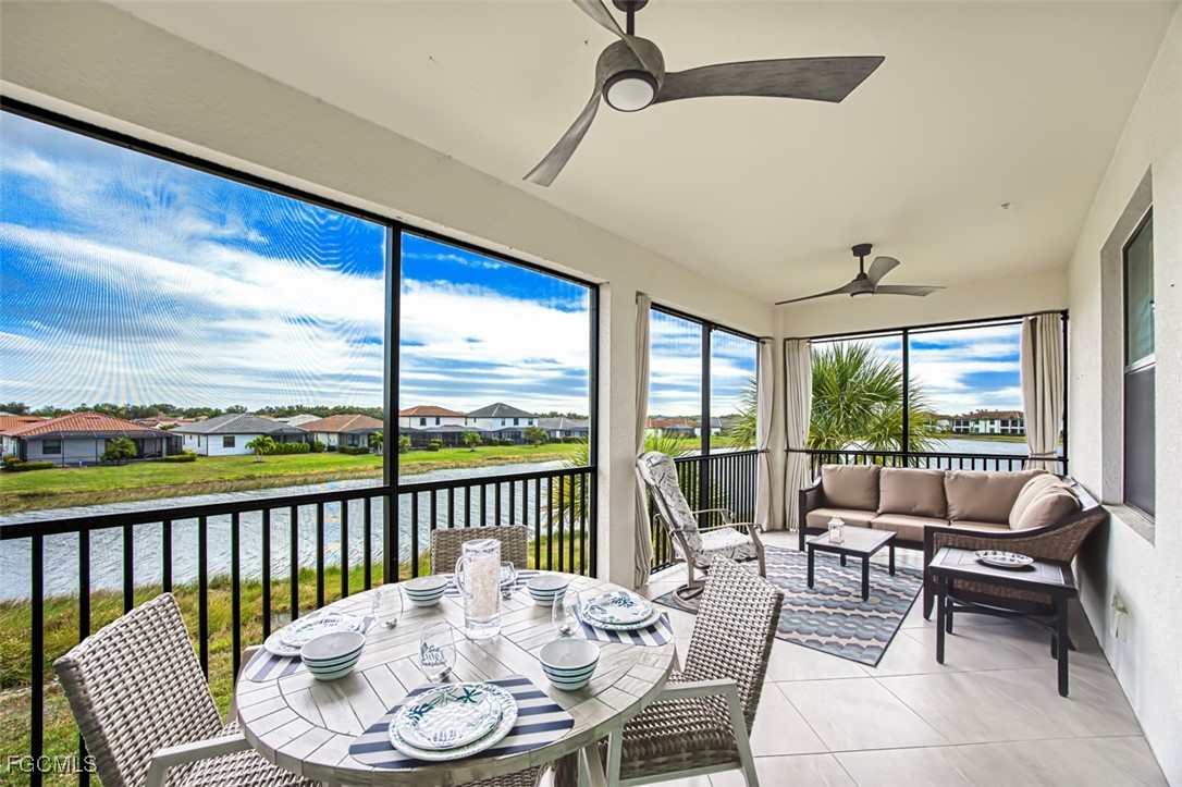 12000 Hawthorn Lake Drive, Unit 202 Fort Myers, FL 33913 - Photo 9 of 49 a dining room with furniture a chandelier and a floor to ceiling window
