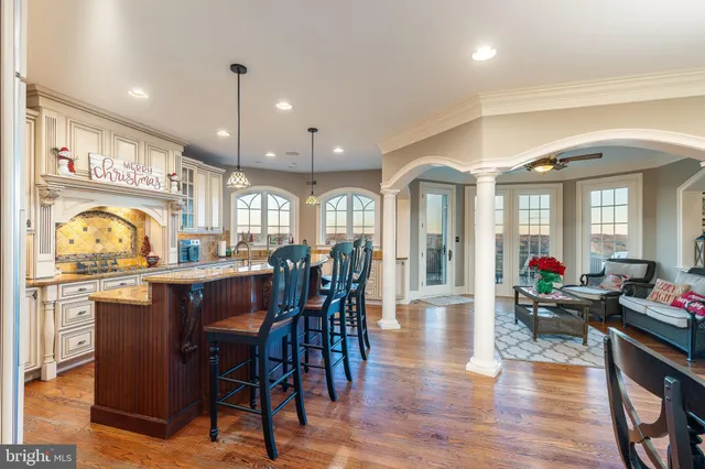 a large kitchen with stainless steel appliances kitchen island granite countertop a large counter top a stove and a sink