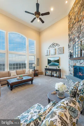 a view of a house with couches and a fireplace