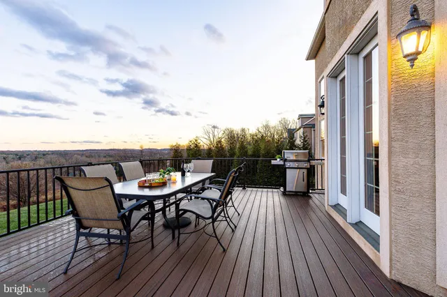 a view of a balcony with a table and chairs