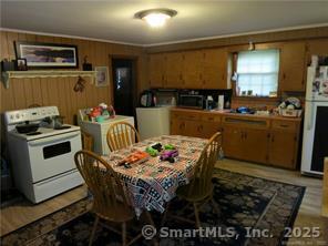 983 Riverside Drive Thompson, CT 06255 - Photo 11 of 16 a kitchen with a dining table and chairs