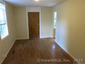 983 Riverside Drive Thompson, CT 06255 - Photo 8 of 16 an empty room with wooden floor and windows
