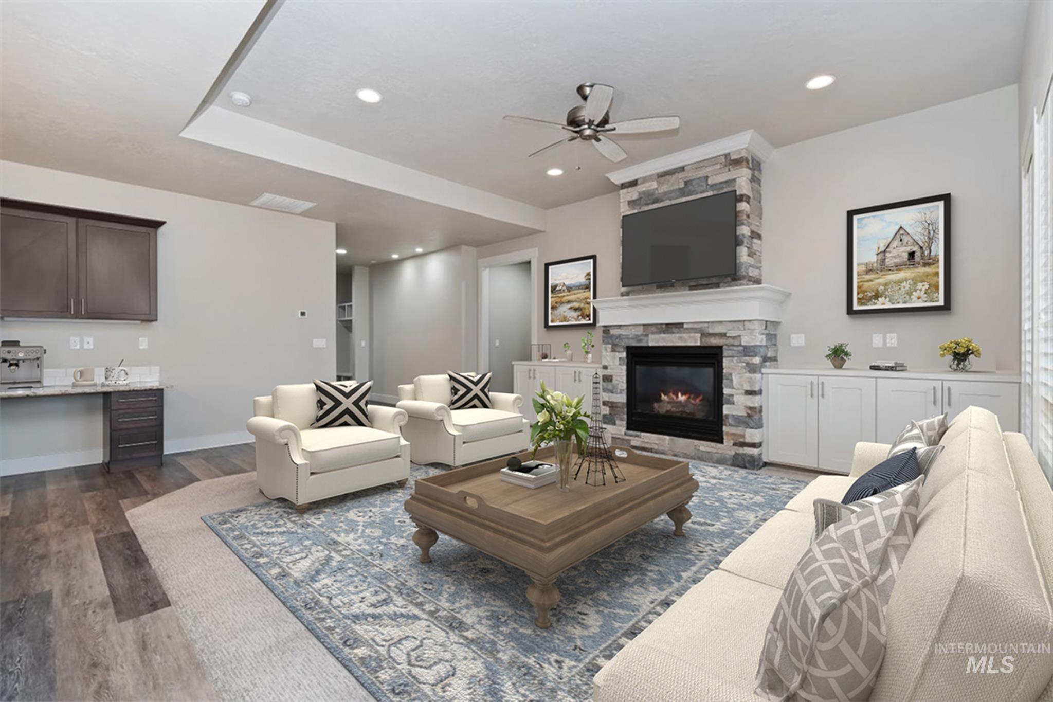 9580 West Ringle Creek Street Star, ID 83669 - Photo 12 of 43 Living room with dark wood finished floors, a ceiling fan, a stone fireplace, and recessed lighting