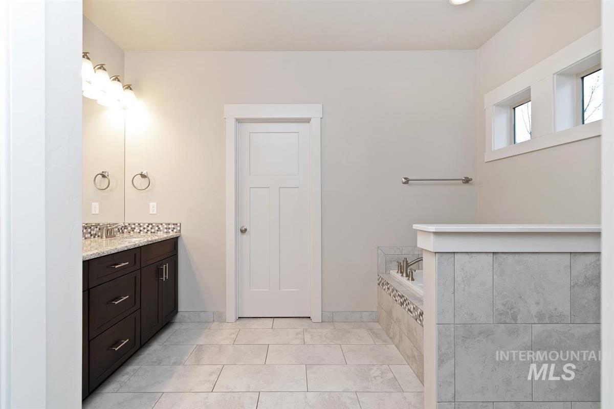 9580 West Ringle Creek Street Star, ID 83669 - Photo 27 of 43 Bathroom featuring vanity, a bath, and light tile patterned flooring