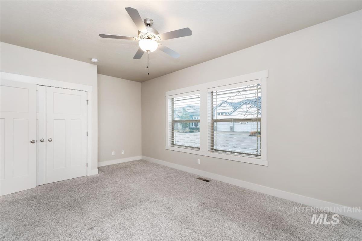 9580 West Ringle Creek Street Star, ID 83669 - Photo 31 of 43 Unfurnished bedroom with a closet, carpet floors, and a ceiling fan