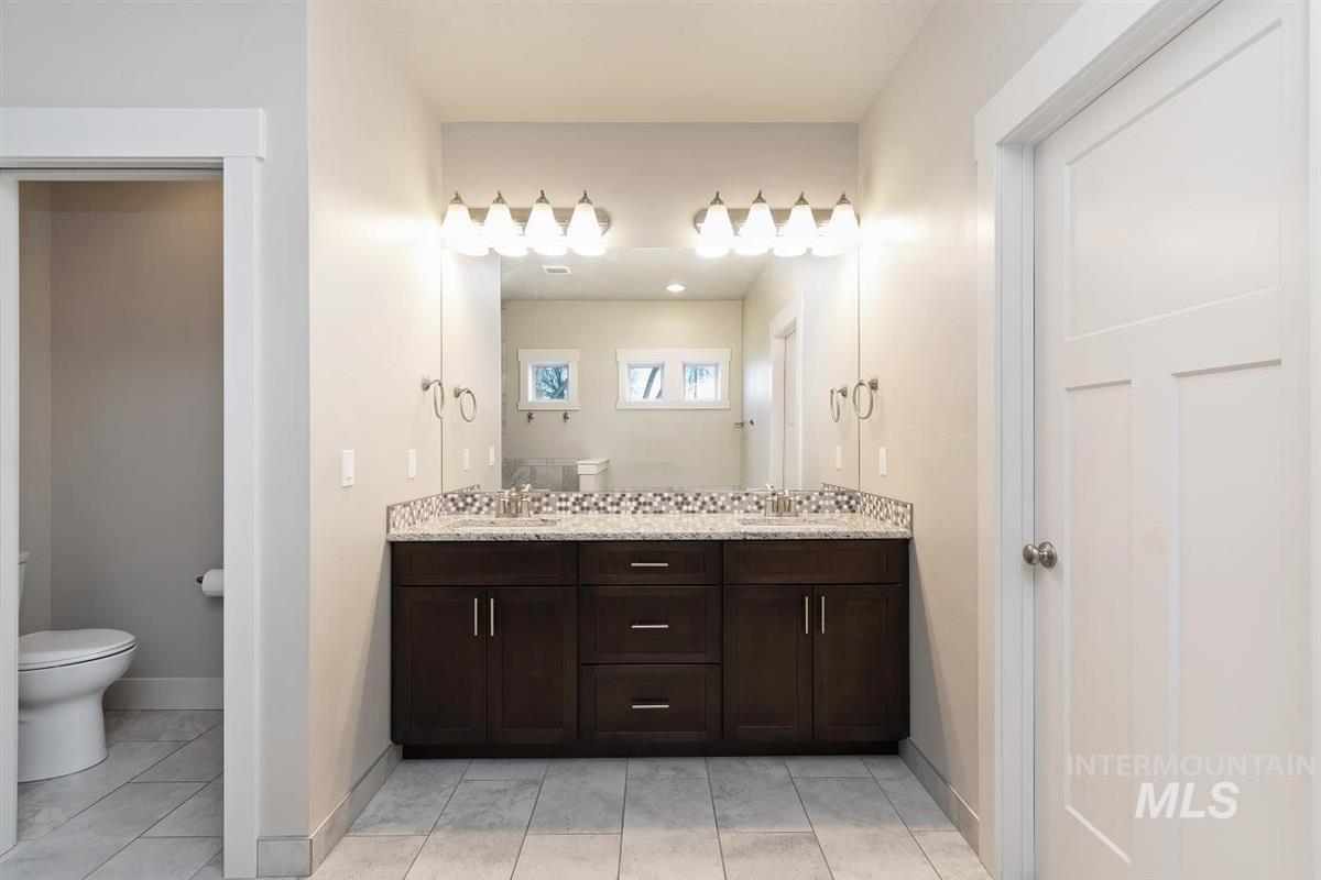 9580 West Ringle Creek Street Star, ID 83669 - Photo 33 of 43 Bathroom featuring double vanity and light tile patterned floors