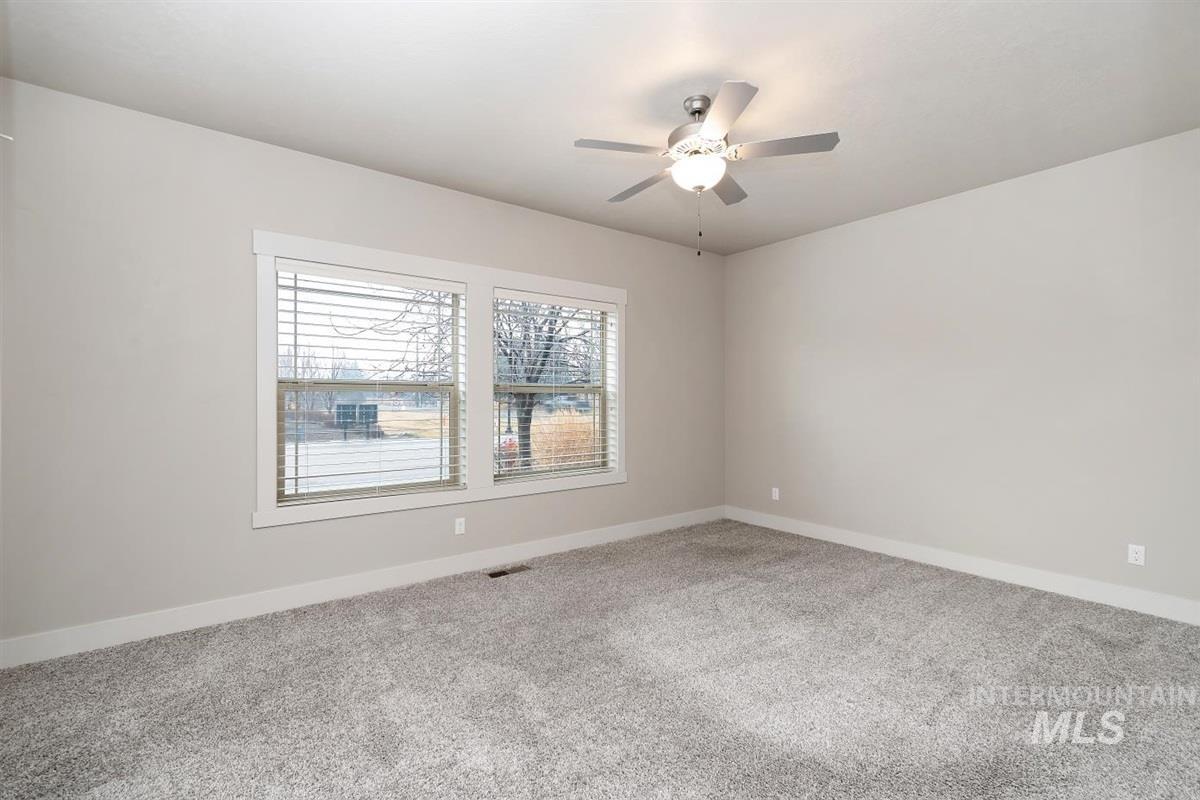 9580 West Ringle Creek Street Star, ID 83669 - Photo 34 of 43 Carpeted empty room with baseboards and ceiling fan