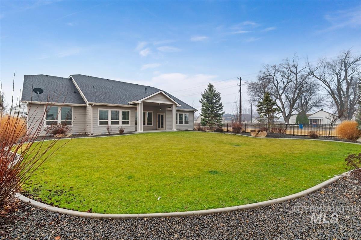 9580 West Ringle Creek Street Star, ID 83669 - Photo 42 of 43 Rear view of house with a fenced backyard, a shingled roof, and a patio