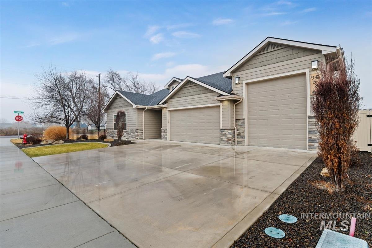 9580 West Ringle Creek Street Star, ID 83669 - Photo 5 of 43 View of front of home with stone siding, a garage, driveway, and roof with shingles