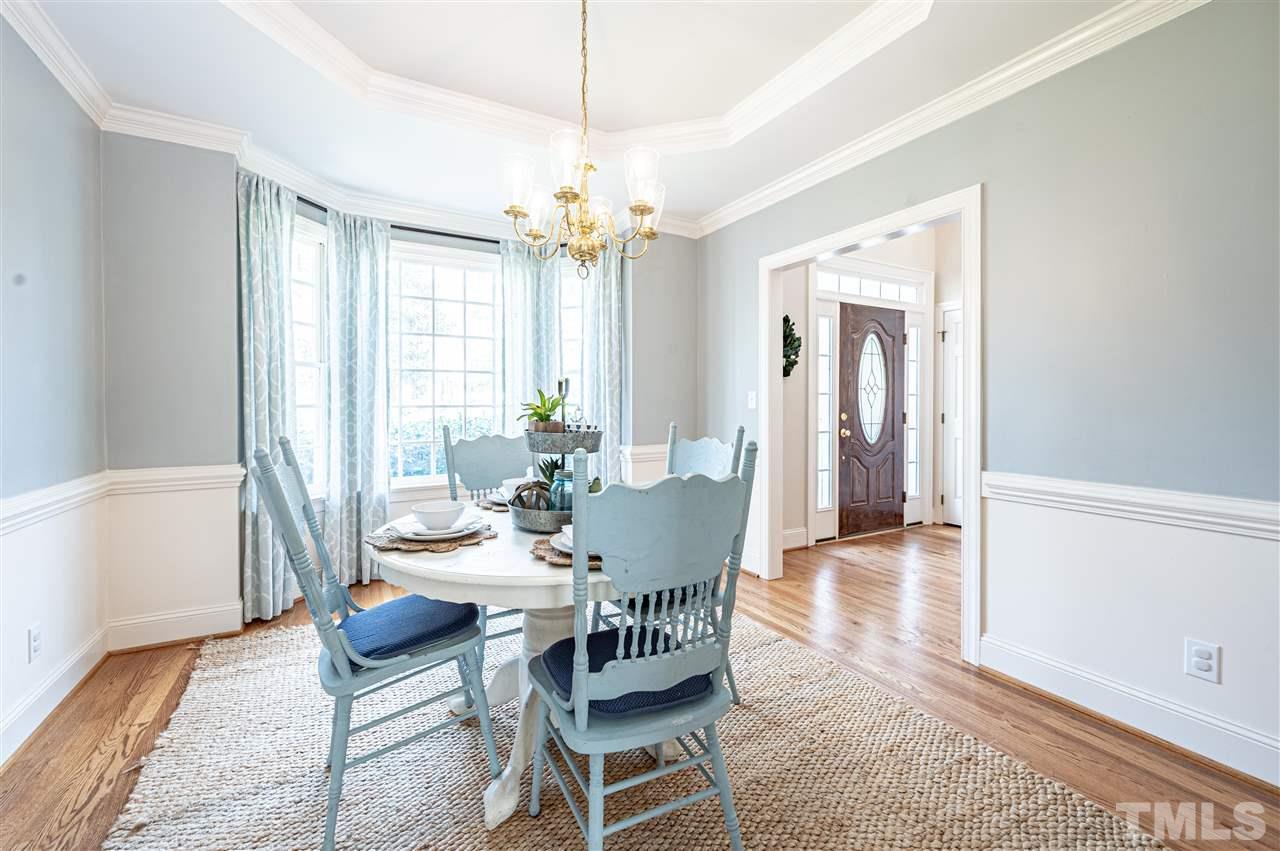 6208 Hampton Ridge Road Raleigh, NC 27603 - Photo 12 of 30 a view of a dining room with furniture window and wooden floor