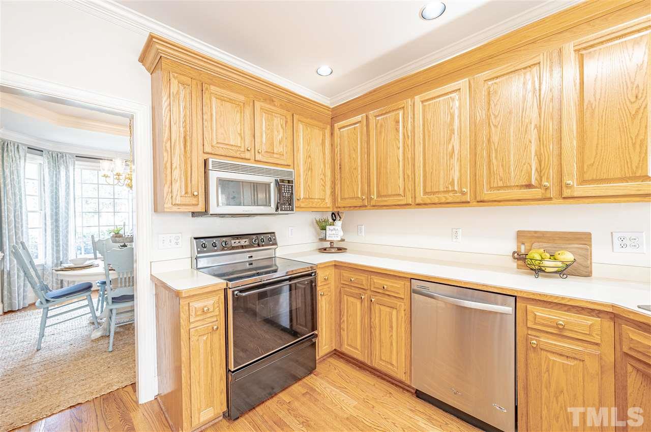 6208 Hampton Ridge Road Raleigh, NC 27603 - Photo 17 of 30 a kitchen with stainless steel appliances granite countertop a stove a sink and a microwave