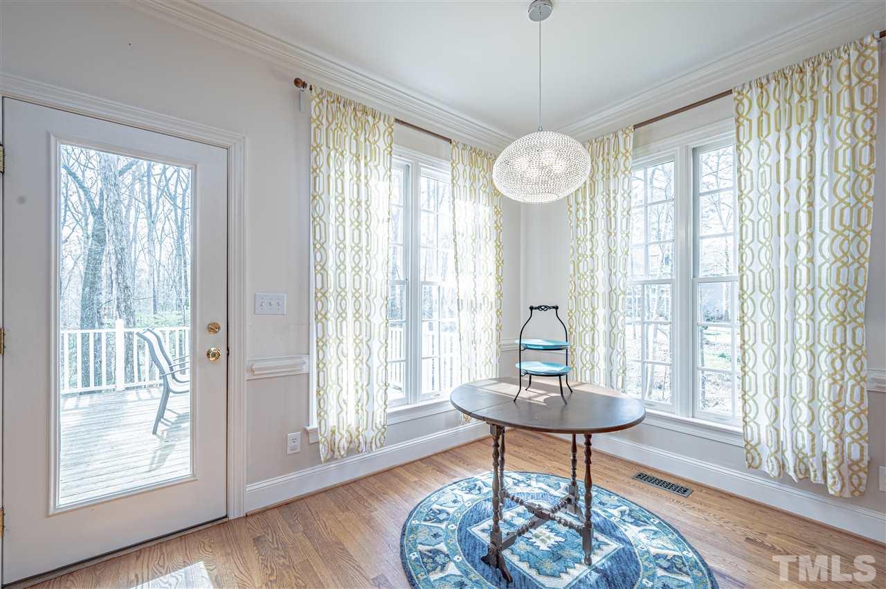 6208 Hampton Ridge Road Raleigh, NC 27603 - Photo 18 of 30 a view of a room with a chandelier and wooden floor