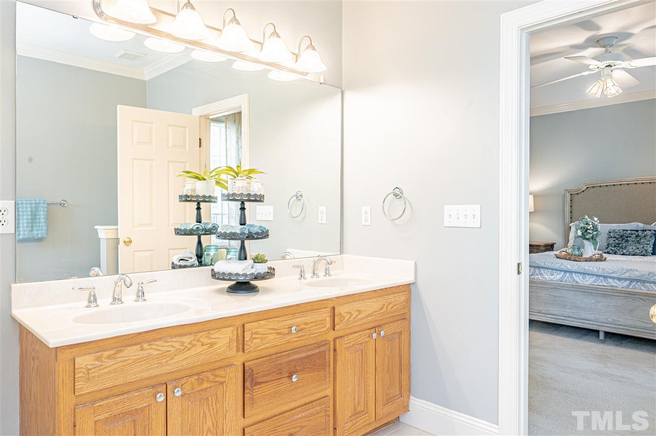 6208 Hampton Ridge Road Raleigh, NC 27603 - Photo 24 of 30 a bathroom with a sink and a mirror