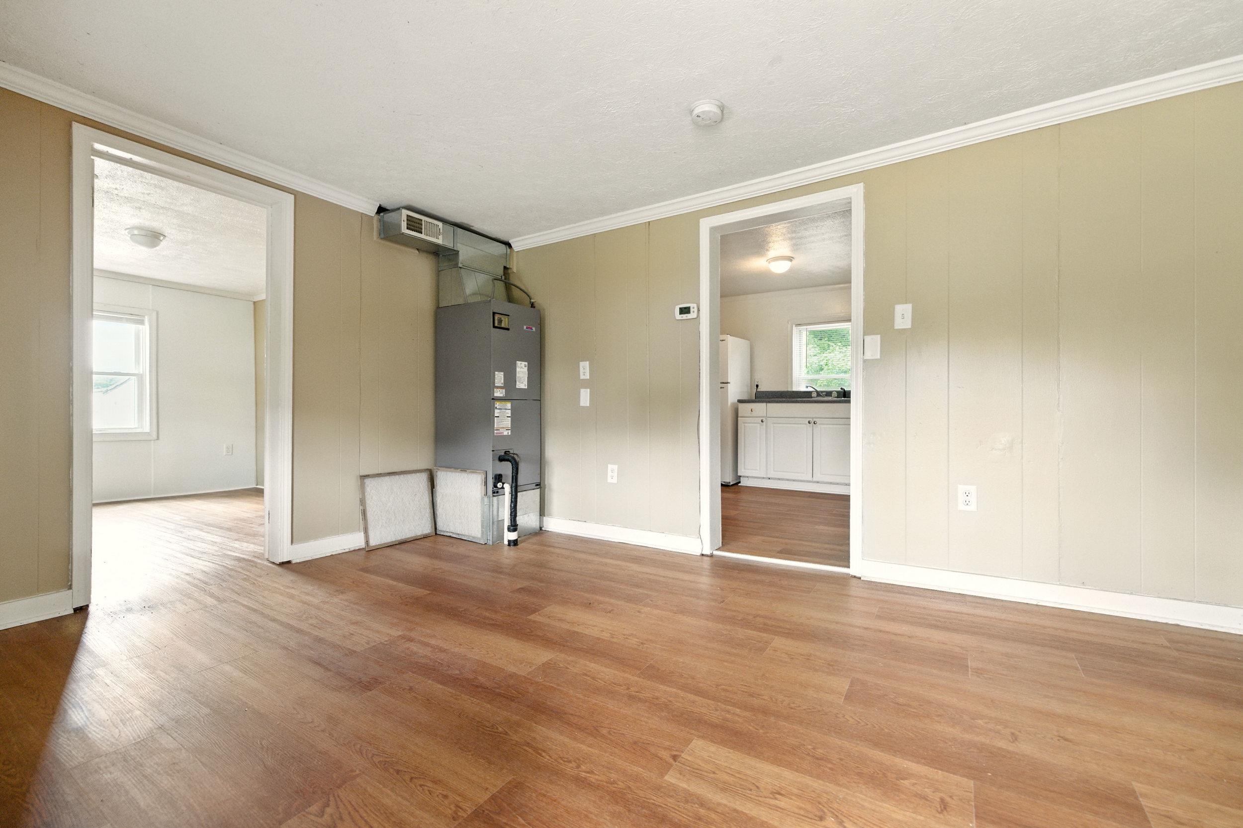 17801 Red Brush Road Elkton, VA 22827 - Photo 11 of 48 a view of an empty room with wooden floor and a bathroom