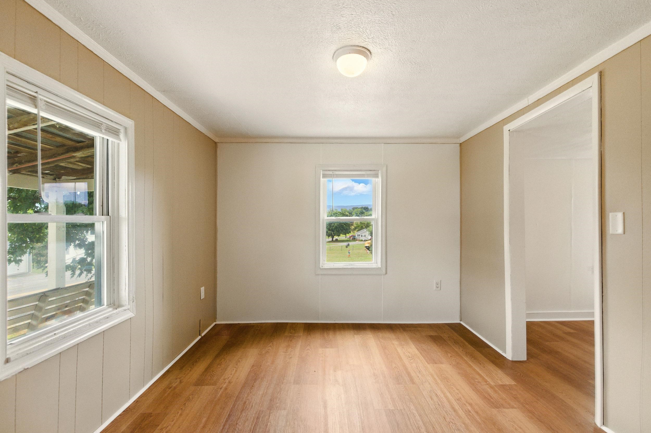 17801 Red Brush Road Elkton, VA 22827 - Photo 12 of 48 an empty room with wooden floor and windows