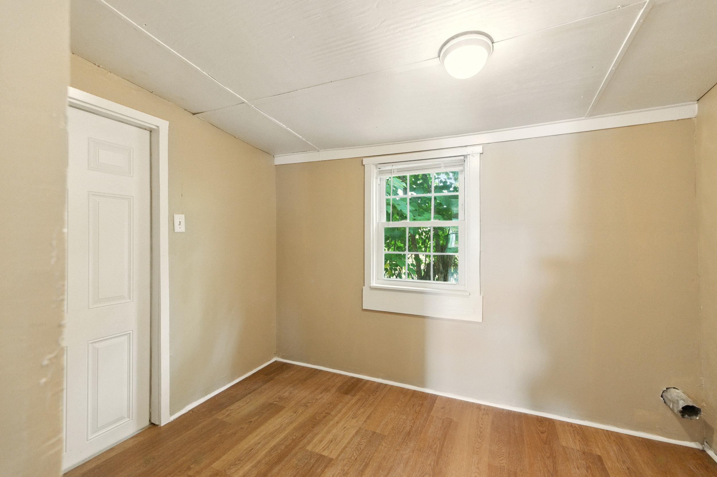 17801 Red Brush Road Elkton, VA 22827 - Photo 18 of 48 an empty room with wooden floor and windows