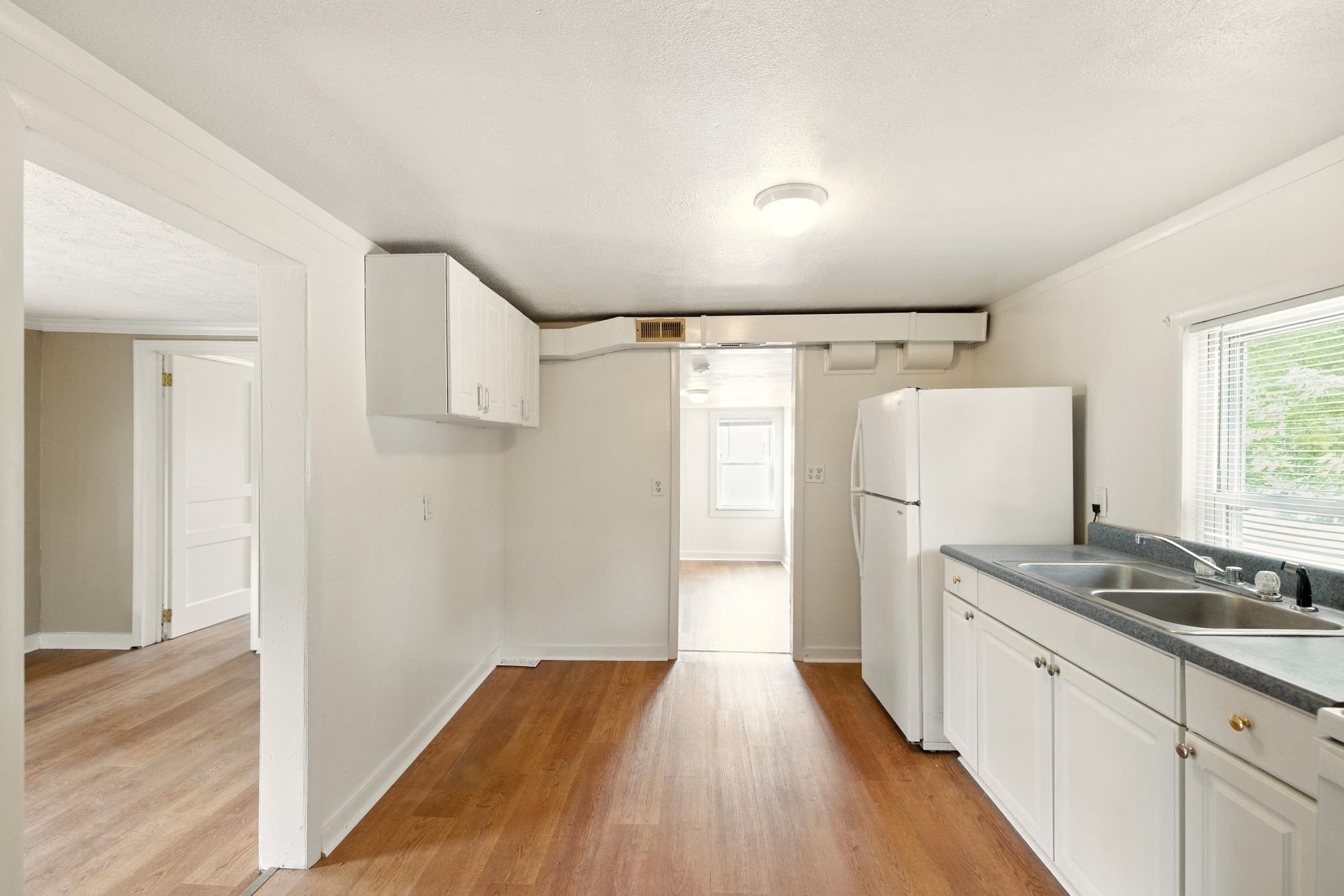 17801 Red Brush Road Elkton, VA 22827 - Photo 3 of 48 a hallway with granite countertop a refrigerator and a sink
