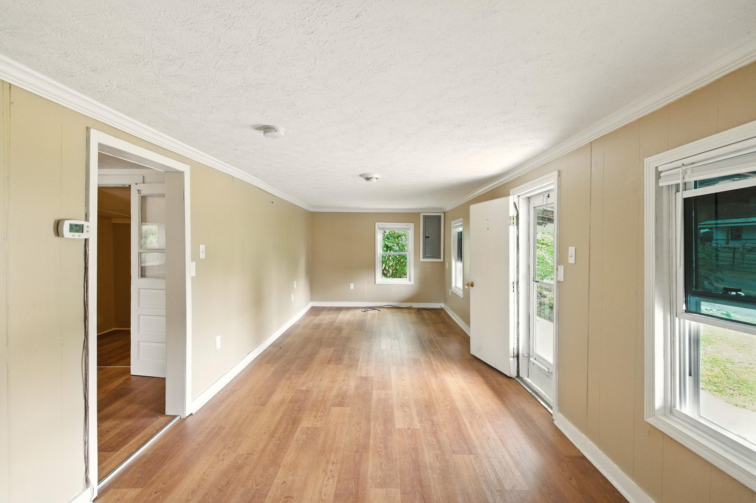 17801 Red Brush Road Elkton, VA 22827 - Photo 8 of 48 a view of a hallway with wooden floor and a living room