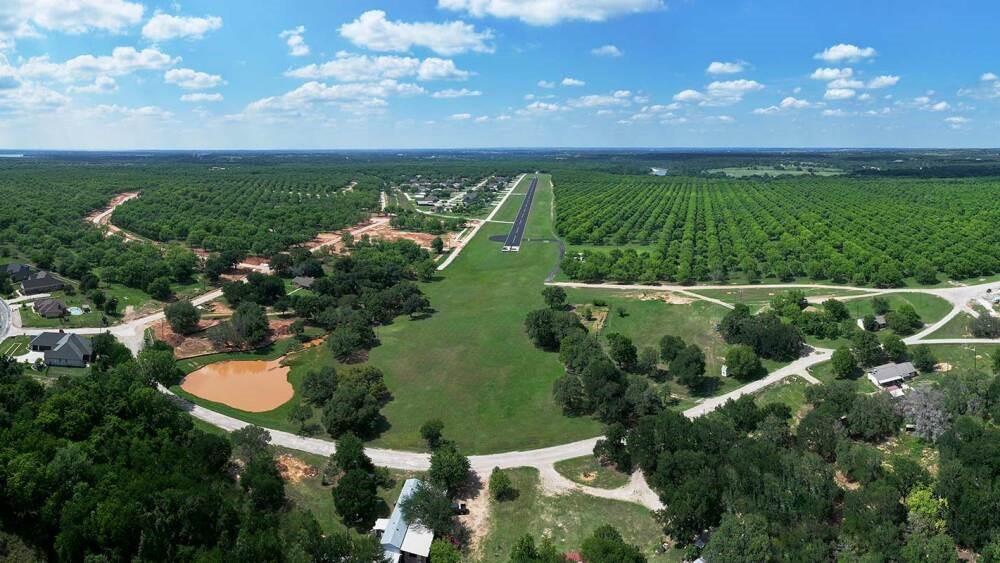 8201 Ravenswood Road Granbury, TX 76049 - Photo 16 of 17 an aerial view of a houses with outdoor space and a lake view in back