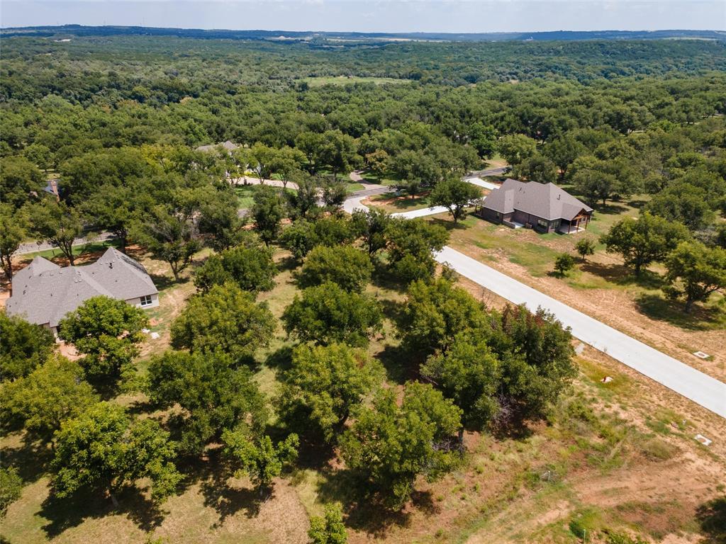 8201 Ravenswood Road Granbury, TX 76049 - Photo 6 of 17 an aerial view of residential houses with outdoor space and trees